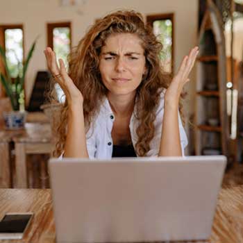 Frustrated Retailer Frustrated independent retailer working at a laptop
